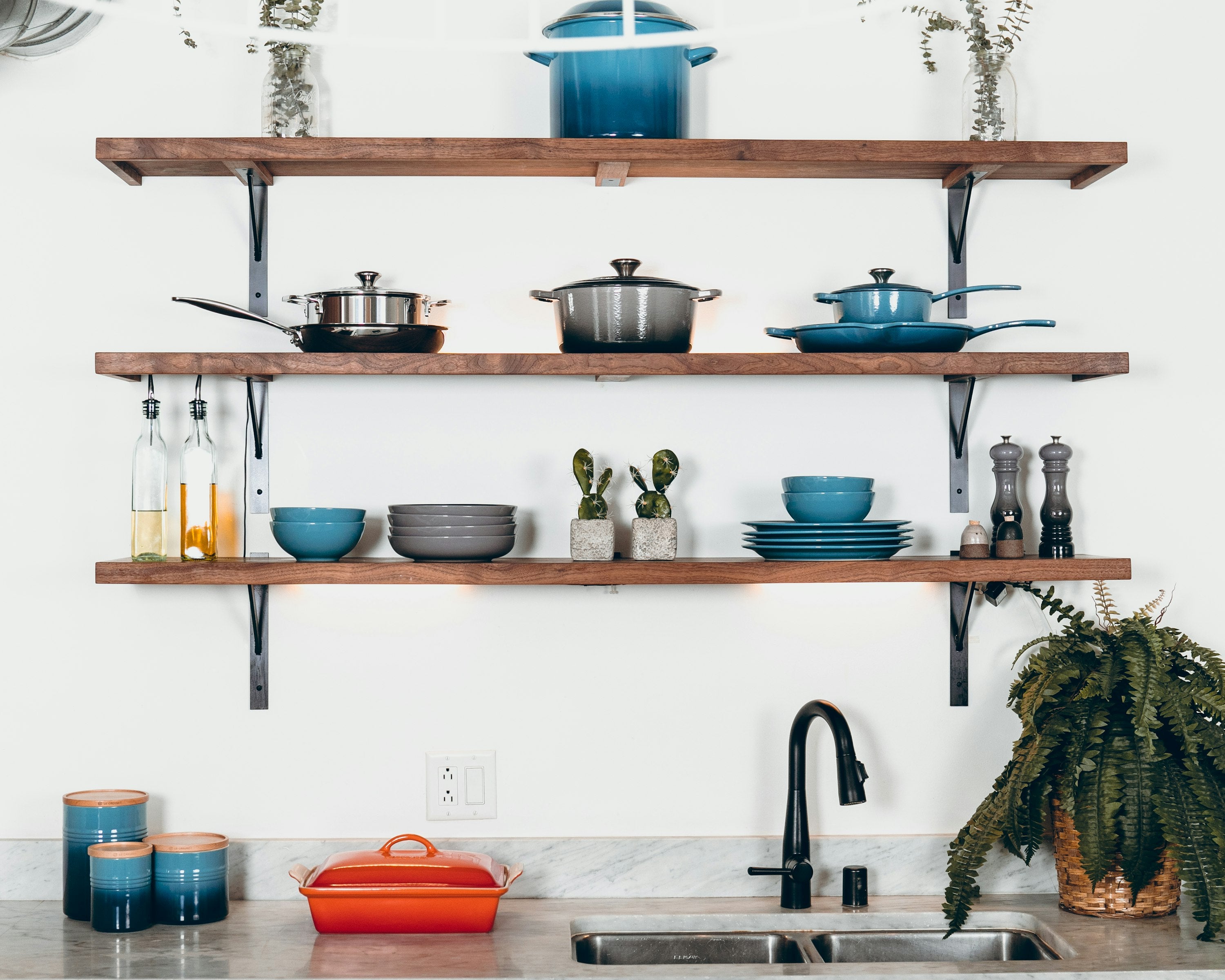 Cookware set styled on kitchen shelves